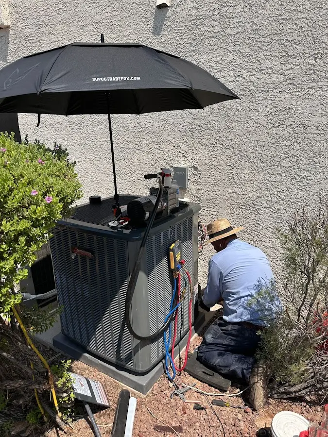 HVAC technician performing outdoor AC maintenance in Kings Park West